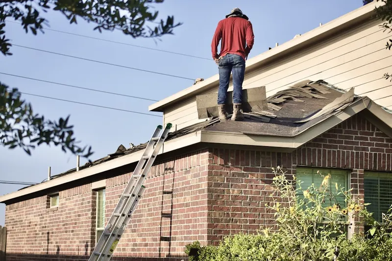 Professional roofer working on a residential roof in Disco